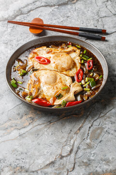 Malaysian Style Soy Sauce Eggs Telur Masak Kicap closeup on the plate on the table. Vertical