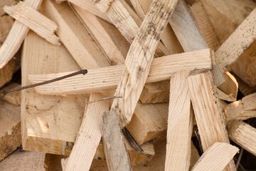 A close-up shot of a pile of wooden planks and other pieces of wood