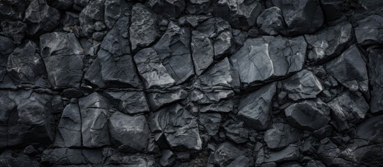Close-up of a black rock texture on a volcanic mountain surface with copy space image.