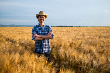 Portrait of happy farmer in his wheat field.