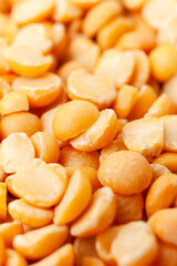 Uncooked, split, yellow peas background. Dry peas grains. Close-up