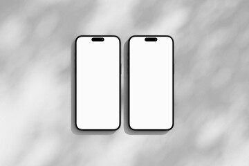 Top view on the two iPhone mobile phones with blank screen