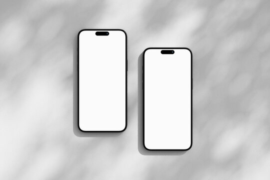 Two iPhone mobile phones with blank screen
