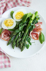 Fresh Asparagus and Prosciutto Salad Served With Boiled Eggs and Microgreens