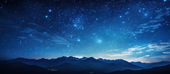 Fototapeta premium Human silhouette watches star trails circling Polaris in the north with a copy space image.