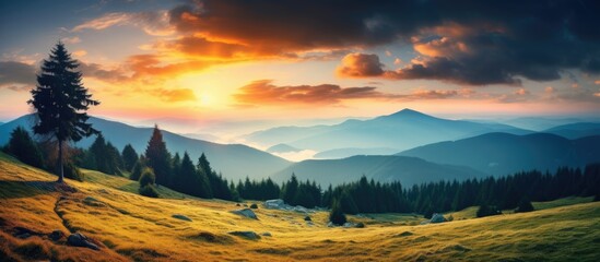 Obraz premium Colorful sunset over a cloudy sky sets the backdrop for an amazing mountain landscape, perfect for a captivating copy space image.