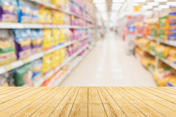 Empty wood table top with spet food shop blurred background