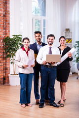 Fototapeta premium Group photo of Indian asian construction company employees looking at camera