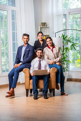 Group of young Indian asian business professionals using laptop in office