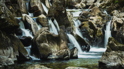 A stone seat in a rocky waterfall