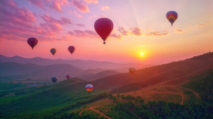 Fototapeta premium Hot air balloons floating in the sky at sunset, with pink and purple hues in the sky