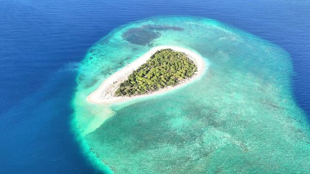 aerial view of clear water waves on white sand beach on tabuhan island banyuwangi east java indonesia. tourist destination in summer.