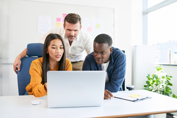 Diverse Team Collaborating on Project in Modern Office
