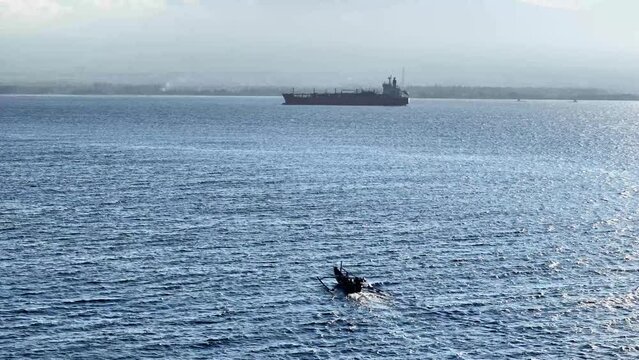 wooden ship sailing fast in blue sea, summer transportation concept in tropical sea.
