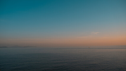 Obraz premium sunset over the sea, orange and green style