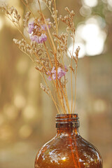 Closeup Dry  Grass Flowers in the bottle with Bokeh background - vintage Patterns with Copy space 