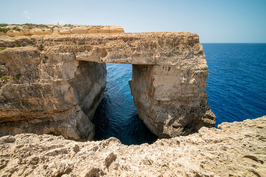 The Wied il-Mielaħ Window is a natural limestone arch on the north-west coast of Gozo . The arch is located at the end of the Salt Valley, north of Gharb