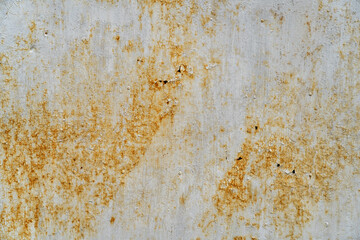 A close-up texture of a rusty metal surface with a white paint base. The surface shows signs of wear and tear with patches of rust and peeling paint