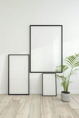 Contemporary minimalist interior with three blank picture frames of varying sizes against a white wall.