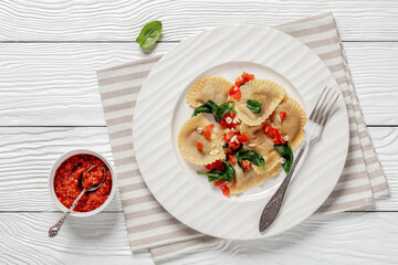 italian pasta mezzelune on a plate, top view