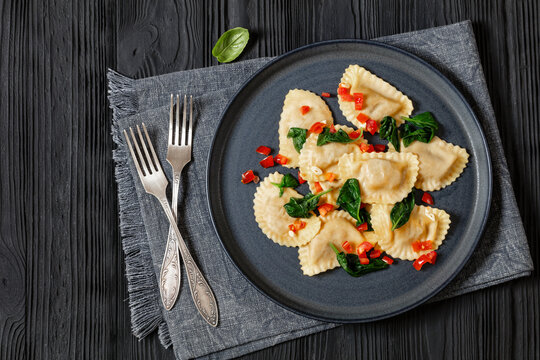 italian pasta mezzelune on a plate, top view