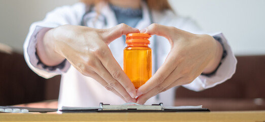 female doctor hand holding a medicine bottle. medical and health care concept