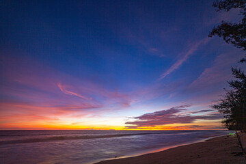 Aerial view day to night dramatic sky with colorful cloudscape..amazing sunset at Karon beach. .Gradient color colorful sky in bright sunset background..Sunset with colorful light rays Gradient color