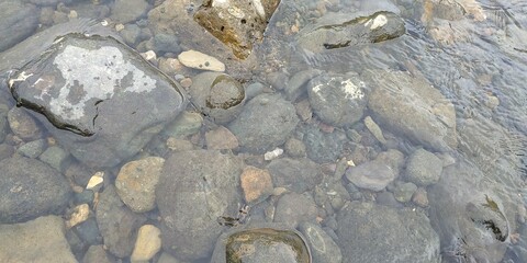 Rocks in stream with smooth flowing water