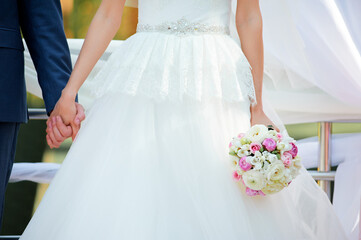 Wedding couple romantic comcept. Bride and groom holding each other hands