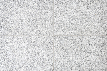  Background of gray tiles granite with a texture of black and white spots.