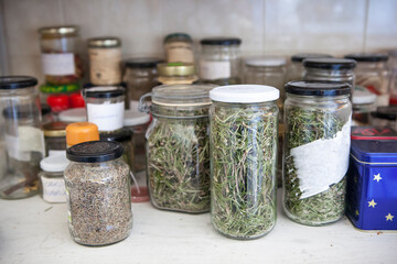 Cupboard full of glass jars with natural home remedies. Closseup