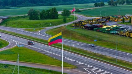 National Pride: Lithuanian Flag Beside the Road, Waving Proudly Over the Scenic Highway