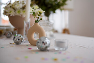Vase with white flowers, mirror ball, selective focus