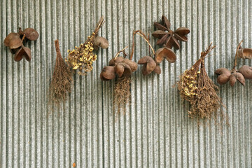 Dry grass and dry flowers hanging on the Old Zinc wall fence - interior design - image from bangsaen thailand 