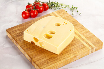 Maasdam cheese brick over board