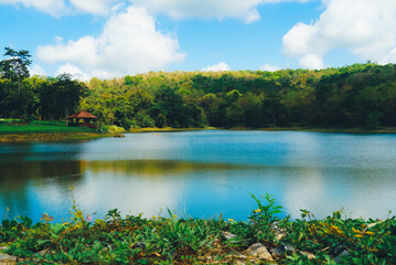 Lake with clear blue sky and white clouds, beautiful endless green mountains and waters at Jedkod Pongkonsao Natural Study in Saraburi, Thailand