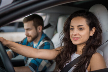 Happy man and woman driving in car while travelling together by auto during summer trip. Travel adventure drive, happy summer vacation concept