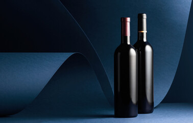 Bottles of red wine on a red background.