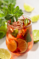 Cocktail Cuba Libre with rum, cola, mint, and lime.