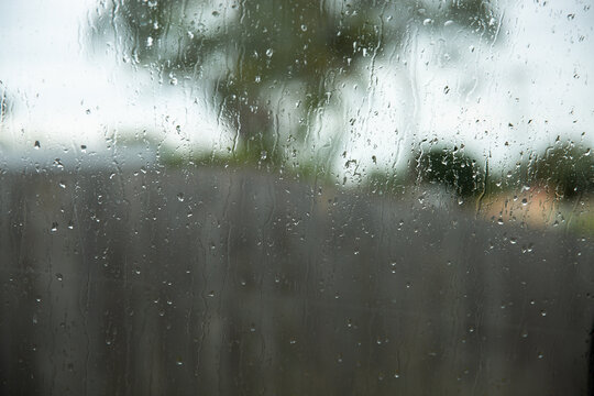 focus on raindrops on a window with a blurry background