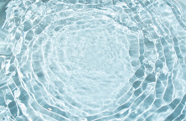 Flowing water with shining wave texture on a pastel  sunlight blue background. Abstract Water...
