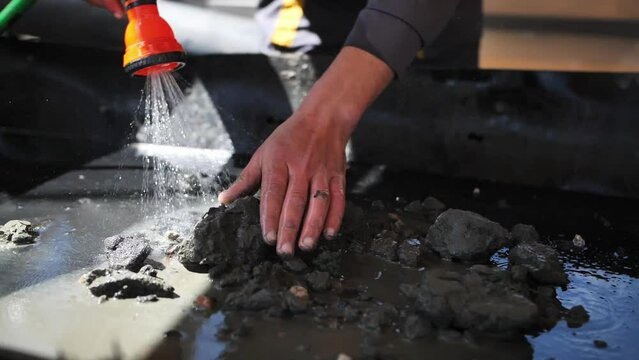 The process of washing amber stones from a ground