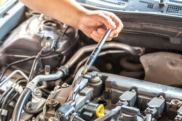 Combustion engine vehicle maintenance, replace of spark plugs