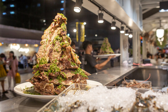 A stack of ribs presented at a counter at Jodd Fairs Night Market in Bangkok, Thailand.