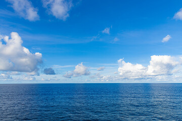 Summer background, beach view. Crystal clear sea water bay. Pristine ocean lagoon sunny cloudy sky, idyllic relaxing seascape. Transparent surface, exotic travel. tropics Mediterranean nature panorama