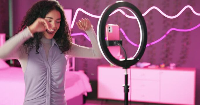 Girl, gen z and dancing on live stream for social media, connection or audience for online. Female person, influencer and bedroom with tripod for video, content creation and tech at home for website