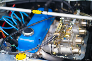 Obraz premium Shiny and well maintained engine inside the car. Bright blue car engine color. Auto fuel mixer