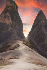 Beautiful fabulous landscape, dramatic sky. The road through the mountains with caves leading to the light. Strange and amazing views.