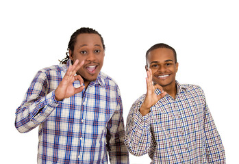 Closeup portrait handsome happy, young men giving ok sign gesture symbol, with hand isolated white...