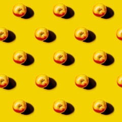 red Apple pattern on bright yellow background. Minimal flat lay food texture. Summer abstract trendy fresh concept.